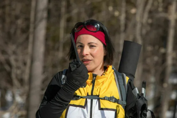 Volunteer ski patroller talking on the radio