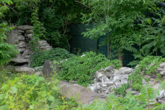 Collapsed limestone masonry wall at Maplelawn Garden