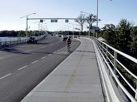 Cars and a cyclist on Champlain Bridge.
