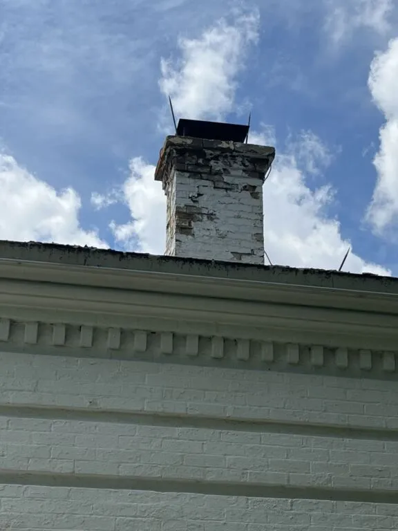 Visible damage to the chimney and roof.