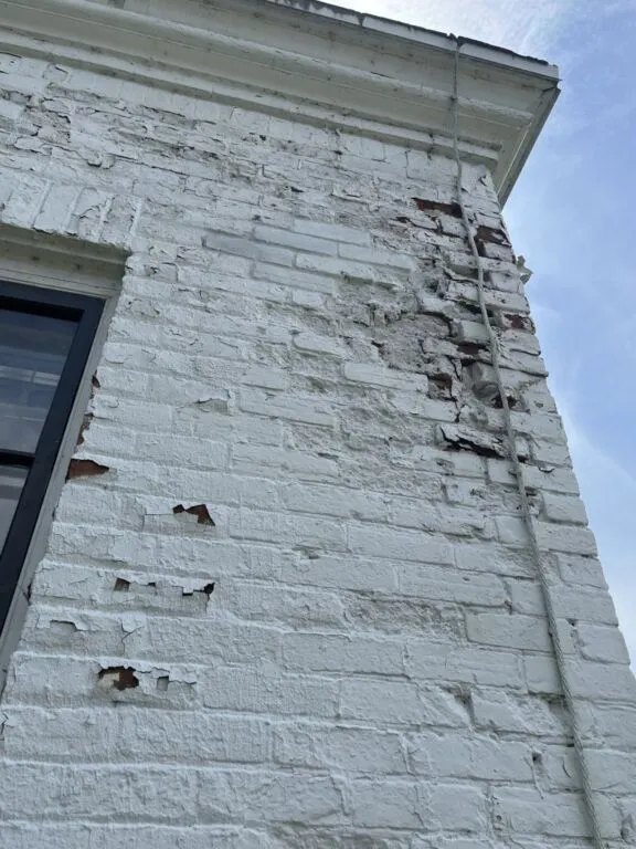 Visible damage to the masonry and foundation.