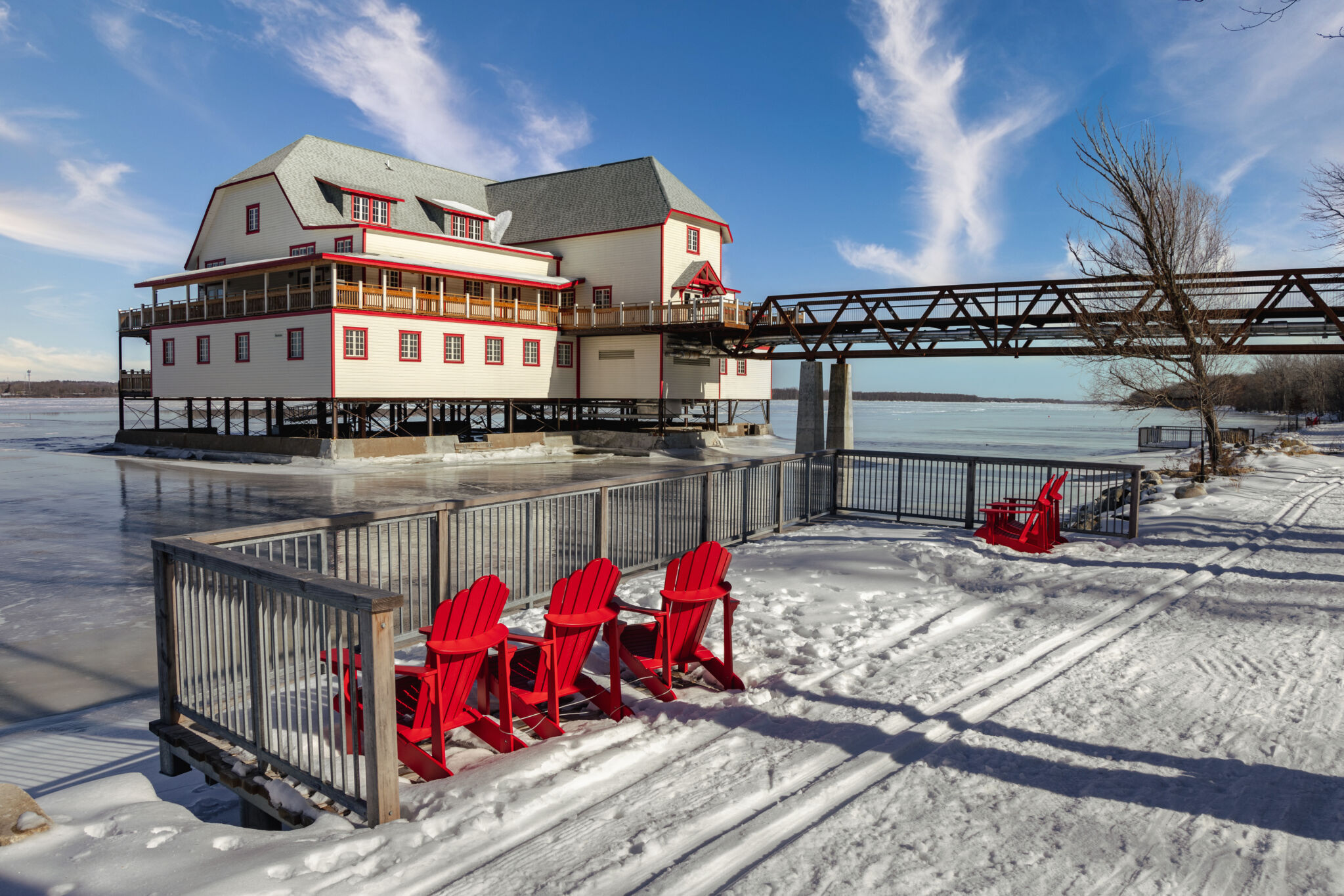 Red chairs along the pathway that leads to the NCC River House, with the historic building visible in the background.