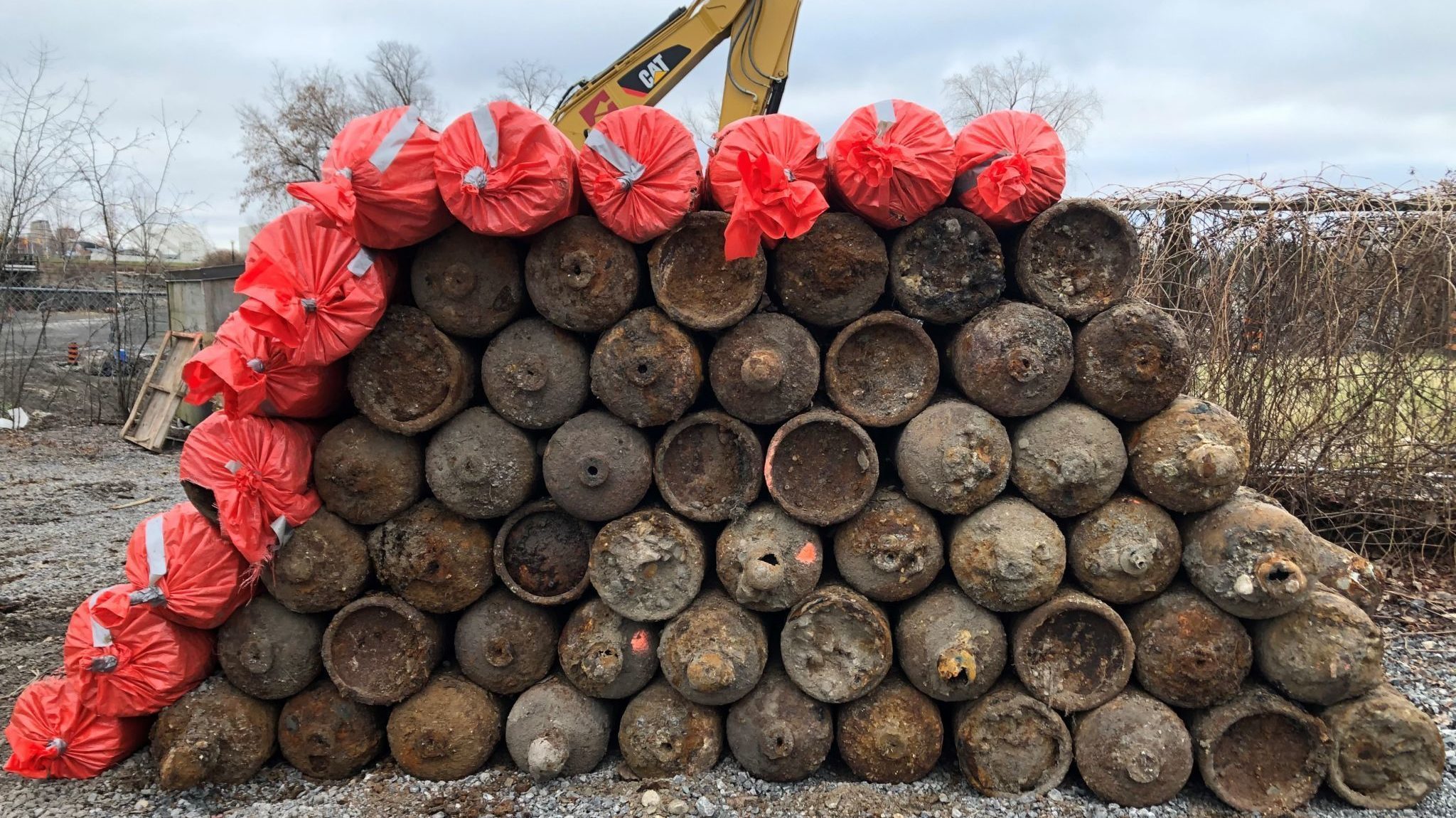 Dozens of gas cylinders piled up.