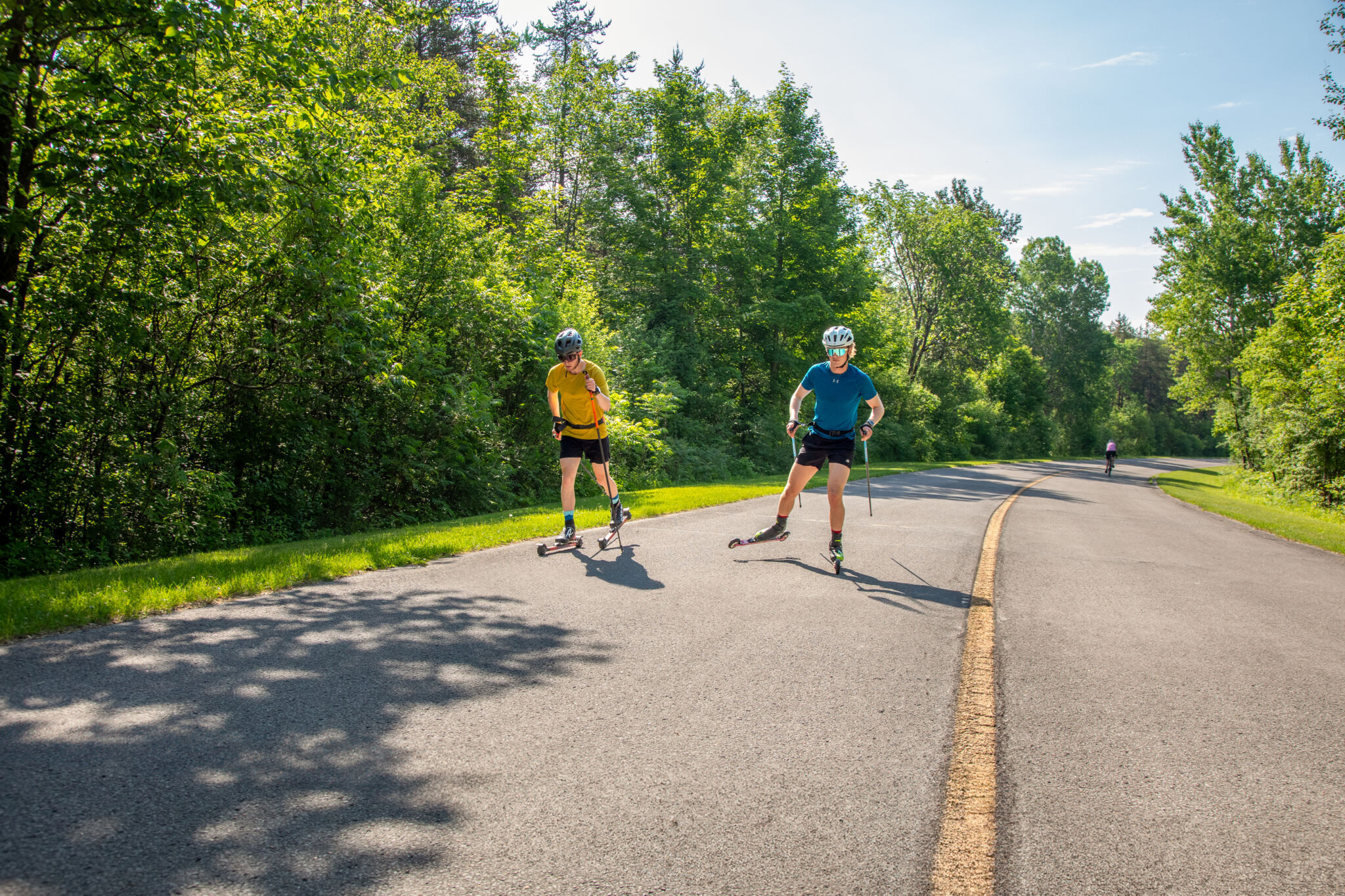 Two people roller skiing on the Gatineau Park parkway
