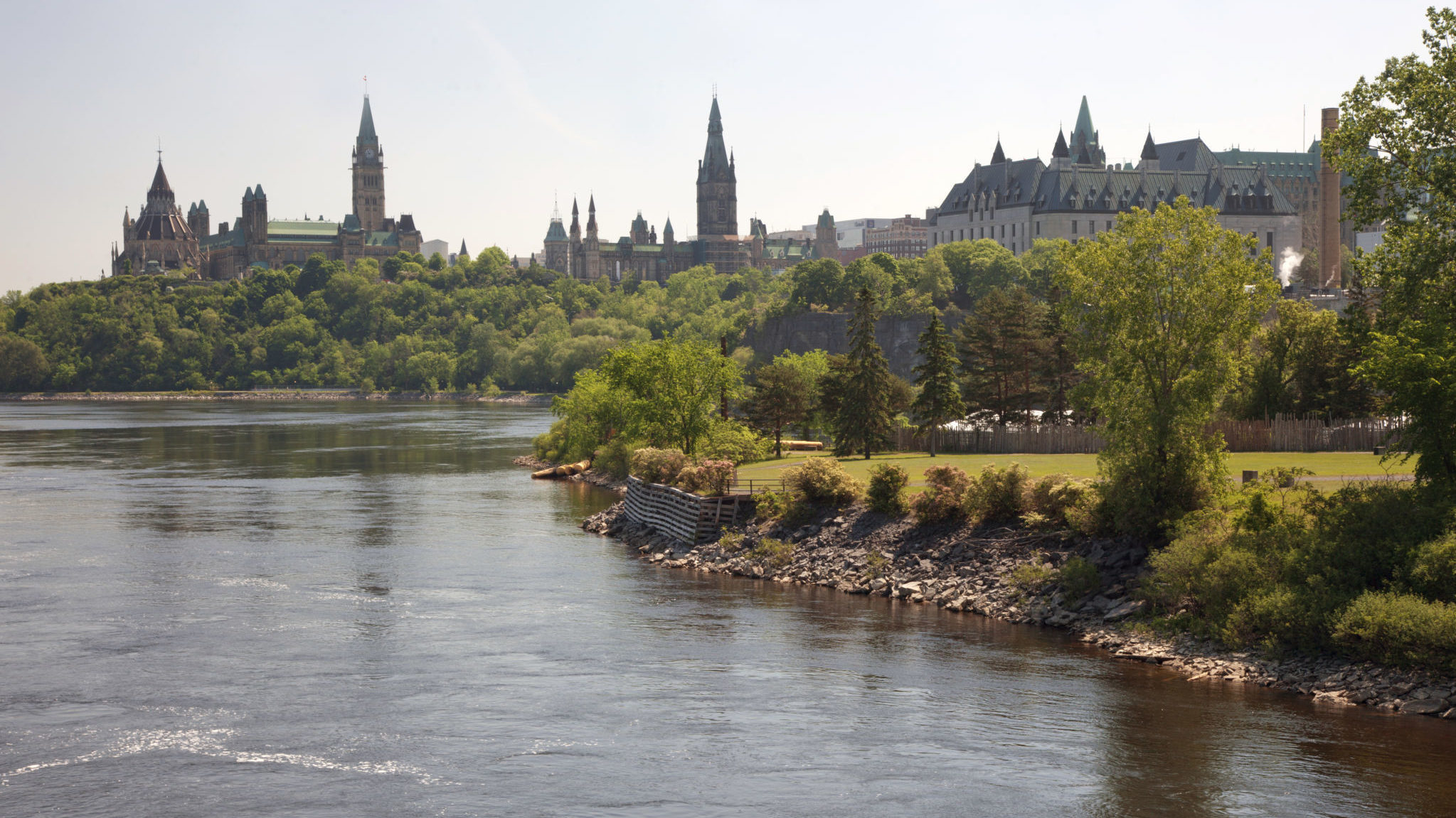 Victoria Island in the summer, with Parliament Hill and the Supreme Court of Canada in the background.