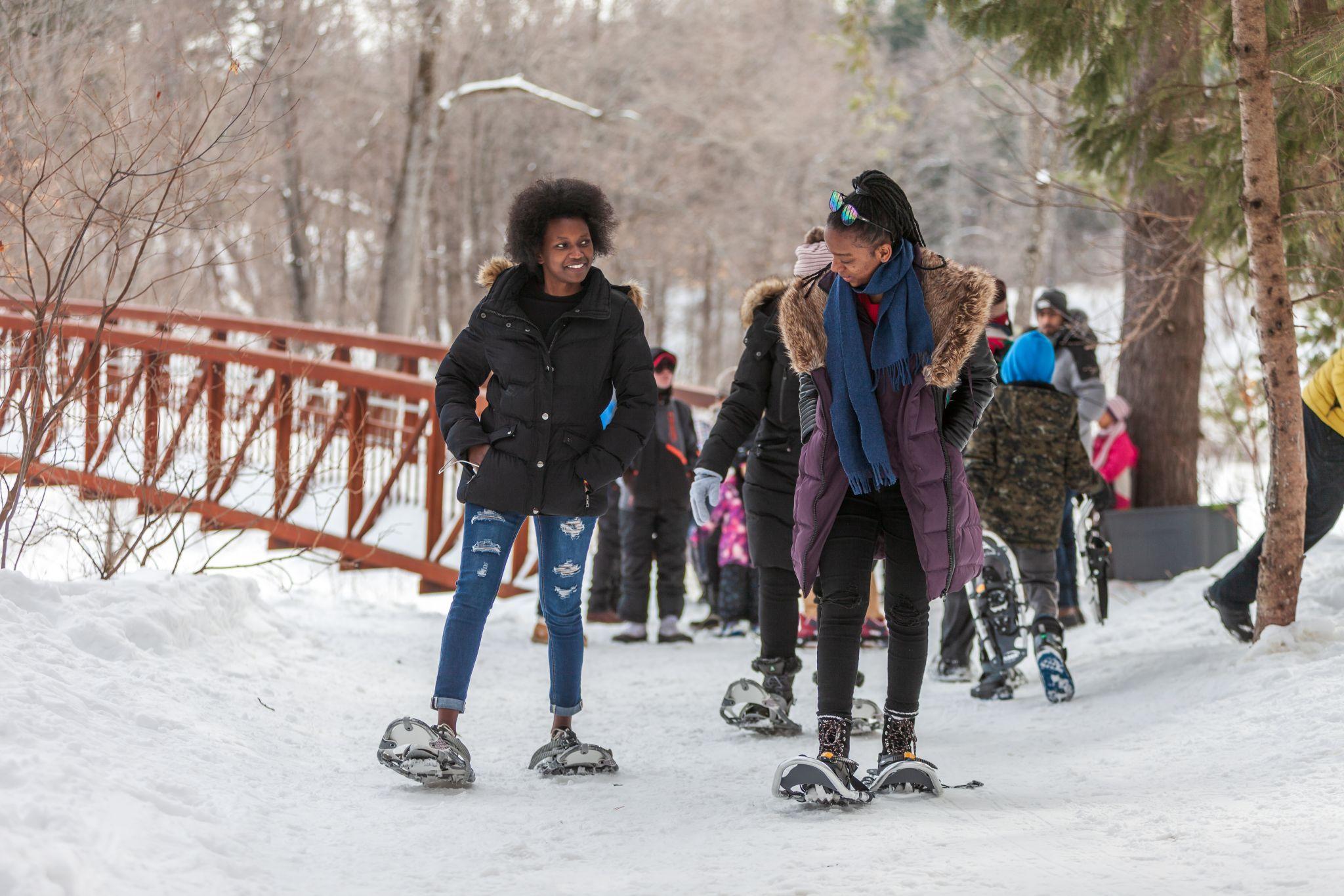 New Canadians trying on snowshoes