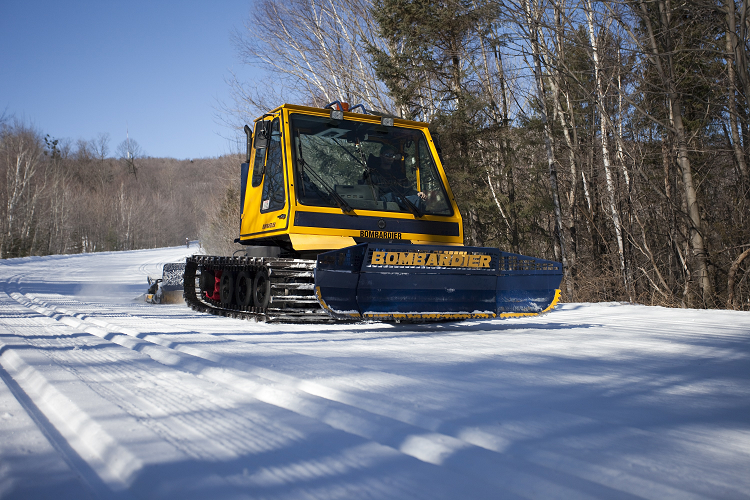 Machine grooming skate-style tracks on a trail, also known as “corduroy”